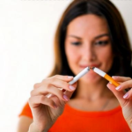 Gros plan isolé d'une femme cassant une cigarette en deux